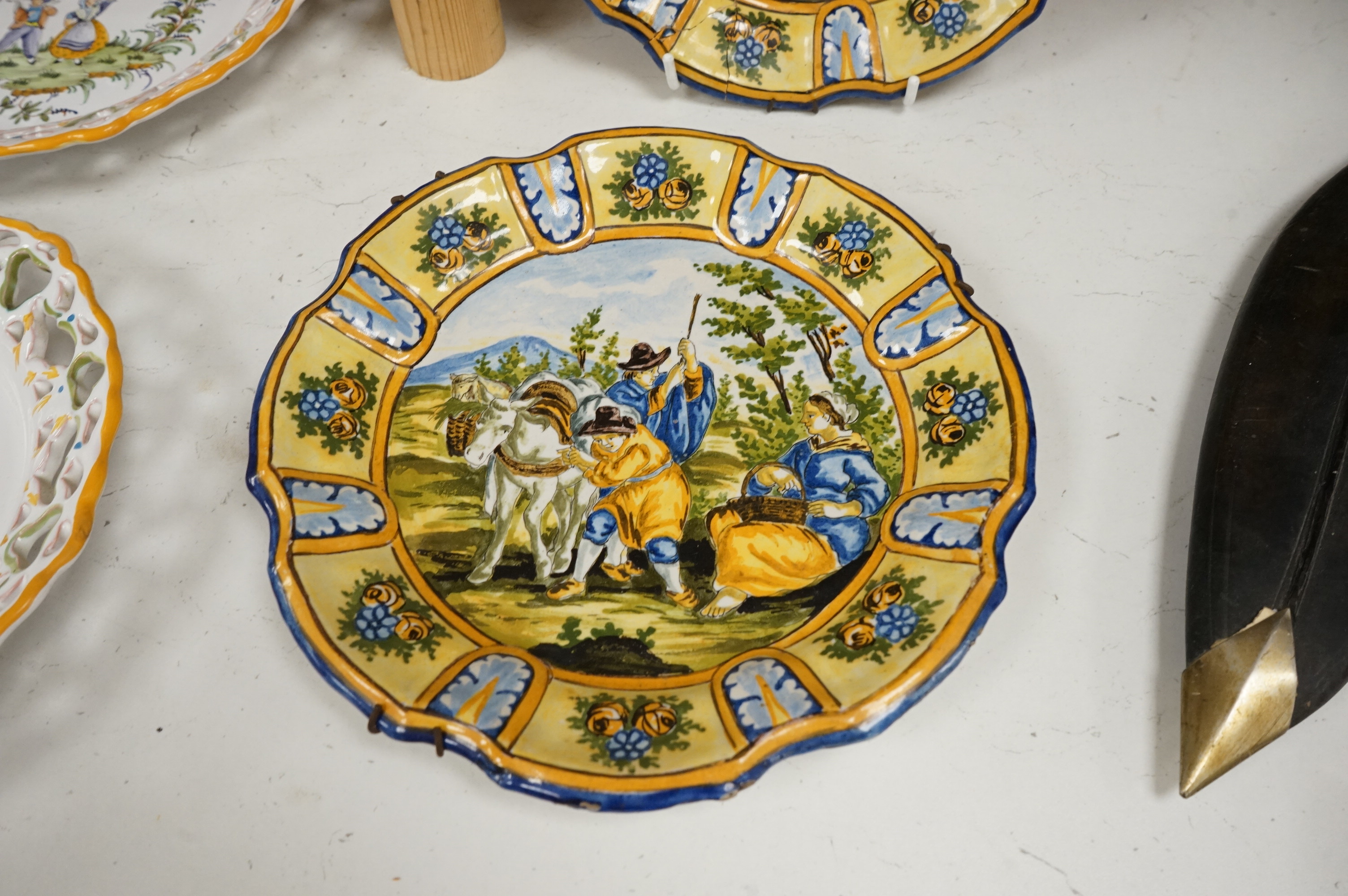 A Delft charger after Artz, together with other faience and majolica dishes, largest 41cm diameter (6)